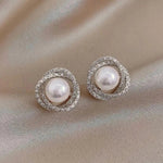 Orecchini a spirale lucidi con eleganti perle - Emma e Gemma