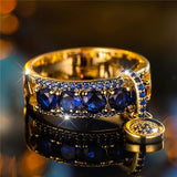 Anello Dichiarativo in Oro Antico e Cristallo Blu - Emma e Gemma